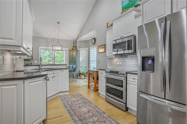 6522 W 133rd Ter, Leawood, KS 66209 - kitchen featuring stainless steel appliances, dark countertops, white cabinetry, decorative backsplash, and high vaulted ceiling