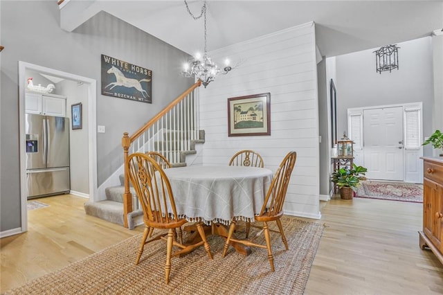6522 W 133rd Ter, Leawood, KS 66209 - dining space featuring a chandelier, stairway, and light wood finished floors