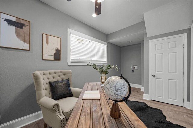 3332 Flora Ave, Kansas City, MO 64109 - living area featuring wood finished floors, a ceiling fan, and baseboards