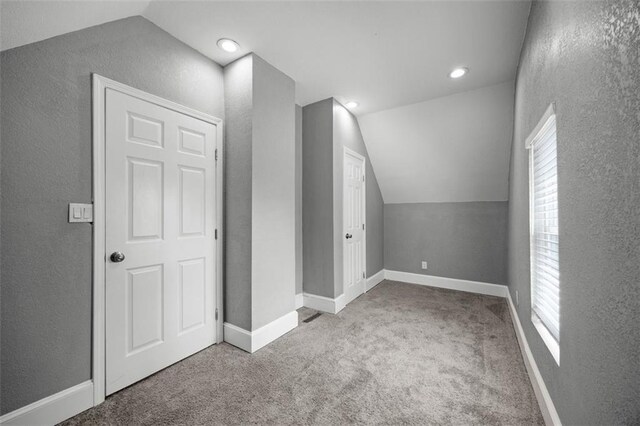 3332 Flora Ave, Kansas City, MO 64109 - bonus room with lofted ceiling, carpet, a textured wall, recessed lighting, and baseboards