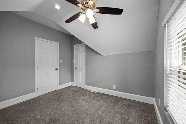 3332 Flora Ave, Kansas City, MO 64109 - additional living space with vaulted ceiling, dark colored carpet, a ceiling fan, baseboards, and recessed lighting