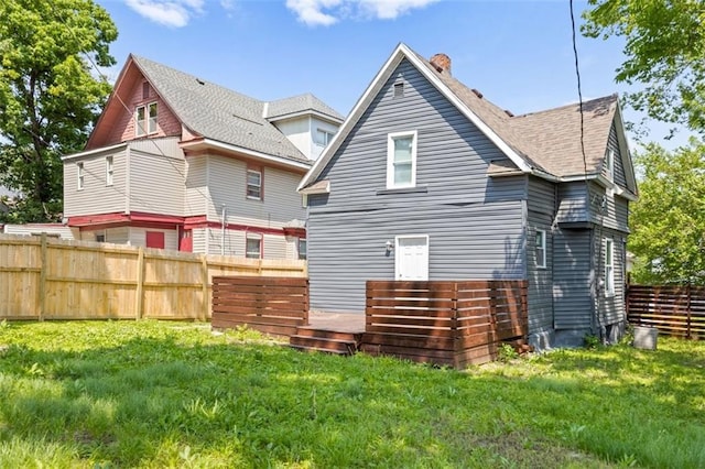 3332 Flora Ave, Kansas City, MO 64109 - back of house featuring roof with shingles