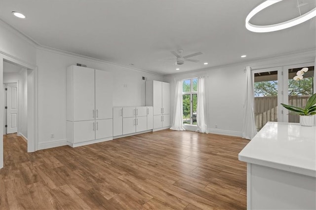 9100 Lamar Ave Unit 107, Overland Park, KS 66207 - unfurnished living room featuring light wood-type flooring, a ceiling fan, recessed lighting, and ornamental molding