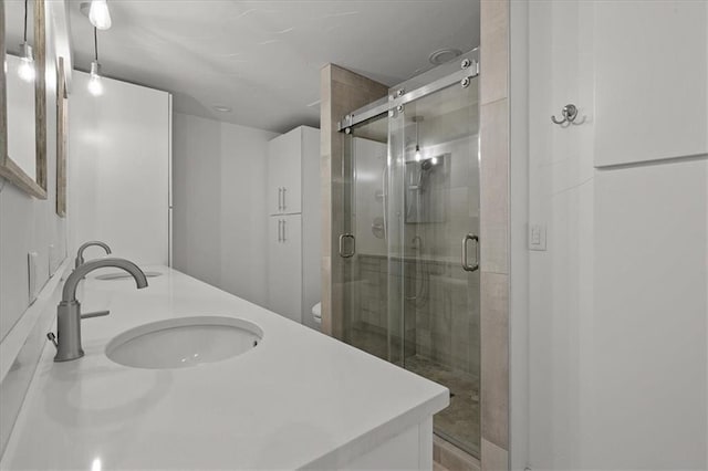 9100 Lamar Ave Unit 107, Overland Park, KS 66207 - bathroom featuring a stall shower and double vanity