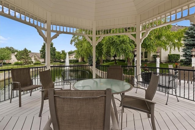 9100 Lamar Ave Unit 107, Overland Park, KS 66207 - wooden terrace featuring a water view and outdoor dining area