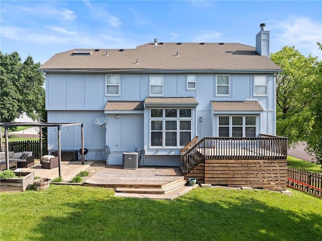 5901 W 158th St, Overland Park, KS 66223 - rear view of house with roof with shingles, a deck, a chimney, and central AC unit