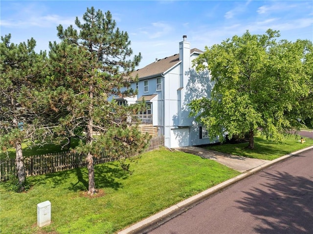 5901 W 158th St, Overland Park, KS 66223 - view of side of home featuring driveway, a chimney, and a garage