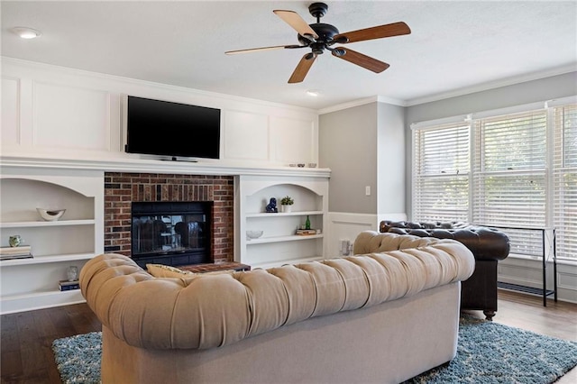 5901 W 158th St, Overland Park, KS 66223 - living area featuring built in features, ornamental molding, dark wood-type flooring, a ceiling fan, and a decorative wall