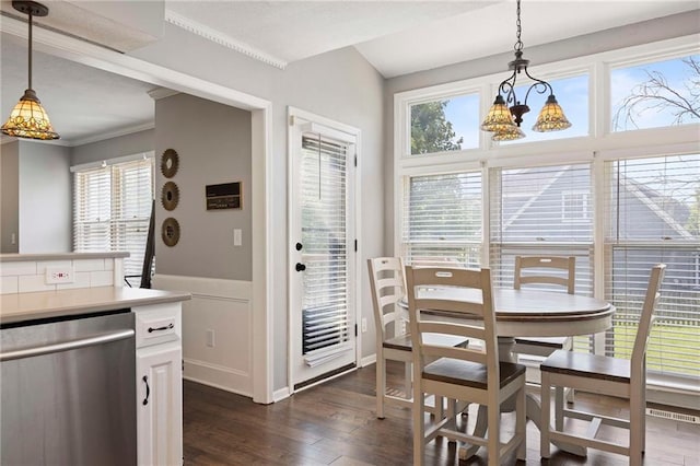 5901 W 158th St, Overland Park, KS 66223 - dining room with healthy amount of natural light, dark wood-type flooring, a chandelier, crown molding, and a wainscoted wall
