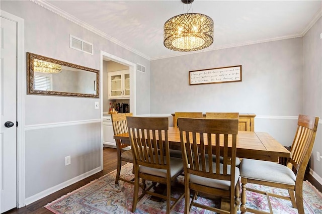 5901 W 158th St, Overland Park, KS 66223 - dining space with dark wood-style floors, a chandelier, baseboards, and ornamental molding