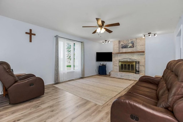 34701 E 235th St, Pleasant Hill, MO 64080 - living area with ceiling fan, rail lighting, a fireplace, and light wood finished floors
