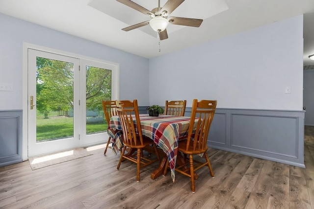34701 E 235th St, Pleasant Hill, MO 64080 - dining area featuring wood finished floors, a ceiling fan, wainscoting, and a decorative wall