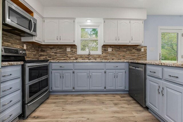34701 E 235th St, Pleasant Hill, MO 64080 - kitchen with appliances with stainless steel finishes, gray cabinetry, a sink, and healthy amount of natural light