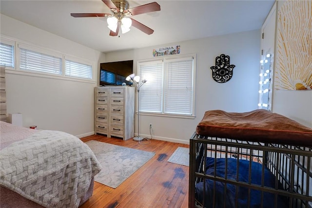 822 S Noland Rd, Independence, MO 64050 - bedroom with wood finished floors, baseboards, and ceiling fan