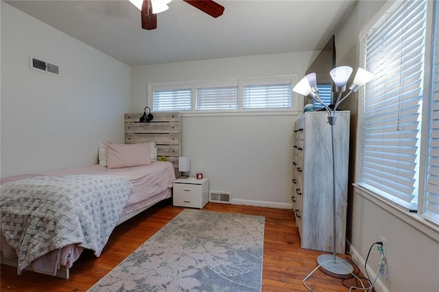 822 S Noland Rd, Independence, MO 64050 - bedroom featuring wood finished floors, ceiling fan, and baseboards