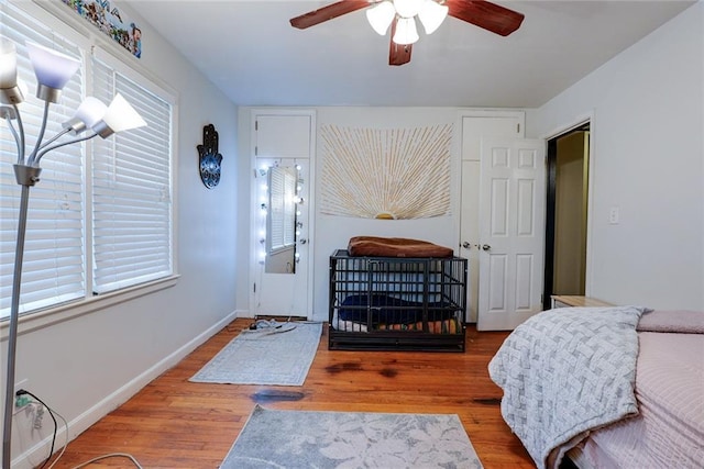 822 S Noland Rd, Independence, MO 64050 - bedroom with wood finished floors, baseboards, and a ceiling fan