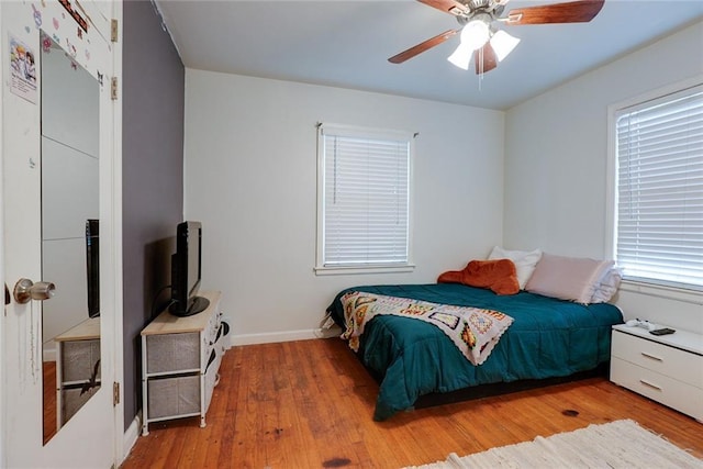 822 S Noland Rd, Independence, MO 64050 - bedroom featuring wood finished floors, baseboards, and ceiling fan