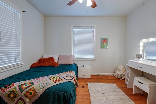 822 S Noland Rd, Independence, MO 64050 - bedroom with wood finished floors, multiple windows, and a ceiling fan