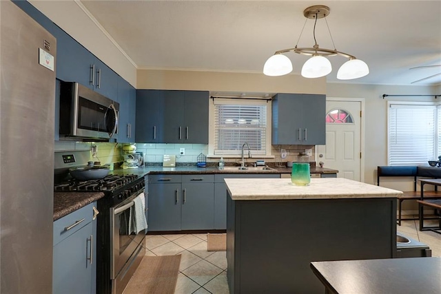 822 S Noland Rd, Independence, MO 64050 - kitchen featuring stainless steel appliances, a sink, decorative backsplash, light tile patterned flooring, and decorative light fixtures