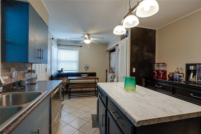 822 S Noland Rd, Independence, MO 64050 - kitchen with a sink, light tile patterned floors, a ceiling fan, a kitchen island, and blue cabinets