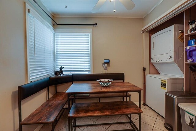 822 S Noland Rd, Independence, MO 64050 - dining room featuring stacked washer / dryer, ornamental molding, light tile patterned floors, and a ceiling fan