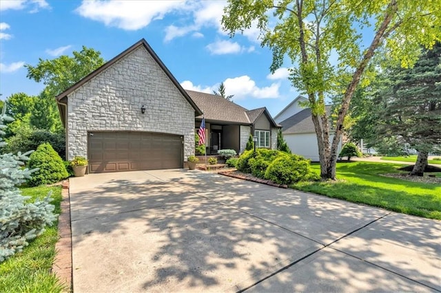8506 W 155th Pl, Overland Park, KS 66223 - view of front of home featuring stone siding, an attached garage, driveway, and a front yard