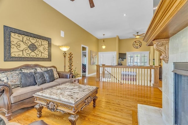 8506 W 155th Pl, Overland Park, KS 66223 - living area featuring ceiling fan, light wood-style floors, baseboards, high vaulted ceiling, and a premium fireplace