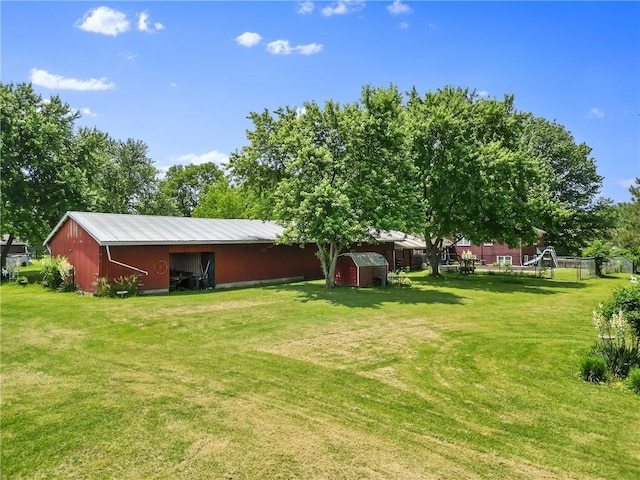 5201 Noland Rd, Kansas City, MO 64133 - view of green lawn featuring an outbuilding and a pole building