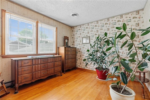 5201 Noland Rd, Kansas City, MO 64133 - sitting room with light wood-style floors, a textured ceiling, and wallpapered walls