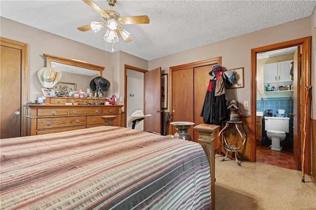 5201 Noland Rd, Kansas City, MO 64133 - bedroom featuring a closet, a textured ceiling, ensuite bath, carpet flooring, and a ceiling fan