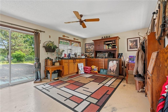 5201 Noland Rd, Kansas City, MO 64133 - office area with healthy amount of natural light, a ceiling fan, concrete floors, and a textured ceiling