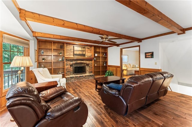 16362 W Briarwood Ct, Olathe, KS 66062 - living area featuring beam ceiling, ceiling fan, wood-type flooring, wainscoting, and a brick fireplace