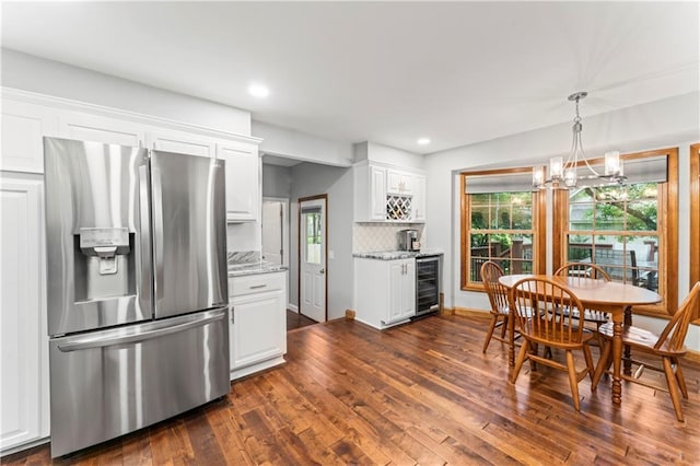 16362 W Briarwood Ct, Olathe, KS 66062 - kitchen with stainless steel fridge with ice dispenser, wine cooler, white cabinets, dark wood-style floors, and healthy amount of natural light