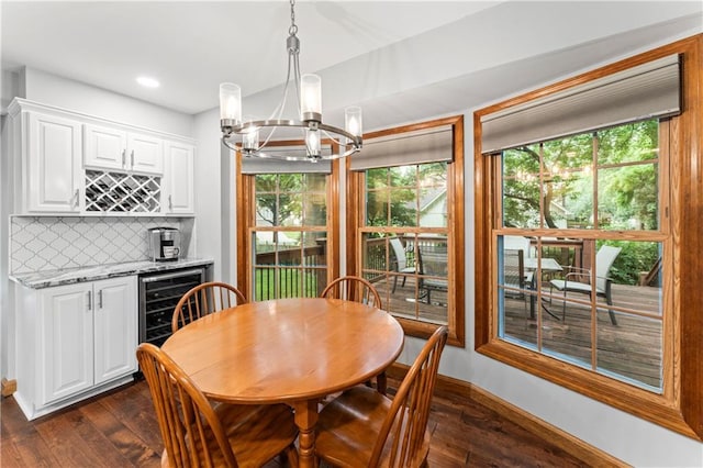16362 W Briarwood Ct, Olathe, KS 66062 - dining room with beverage cooler, a bar, a chandelier, dark wood-style flooring, and recessed lighting