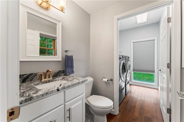 16362 W Briarwood Ct, Olathe, KS 66062 - bathroom with washing machine and dryer, vanity, hardwood / wood-style flooring, and healthy amount of natural light