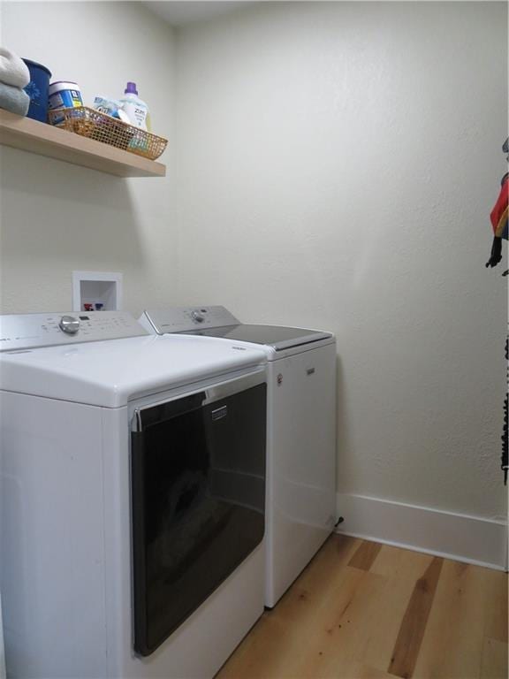 205 W Wea St, Paola, KS 66071 - laundry area with washing machine and dryer and light wood finished floors
