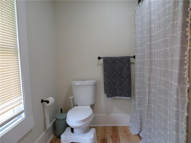 205 W Wea St, Paola, KS 66071 - bathroom featuring wood finished floors and curtained shower
