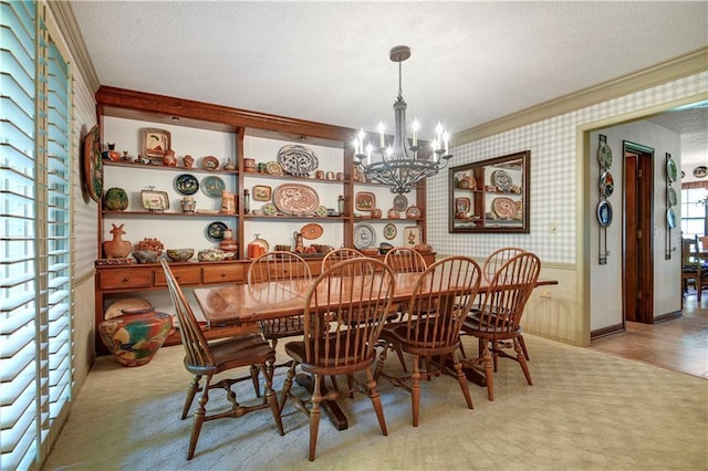 11814 W 149th St, Olathe, KS 66062 - dining room featuring crown molding, a chandelier, light colored carpet, wallpapered walls, and a textured ceiling