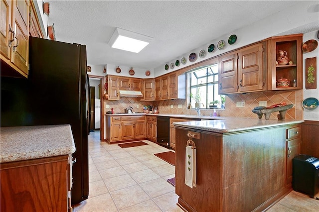 11814 W 149th St, Olathe, KS 66062 - kitchen featuring under cabinet range hood, black appliances, a peninsula, tasteful backsplash, and brown cabinets