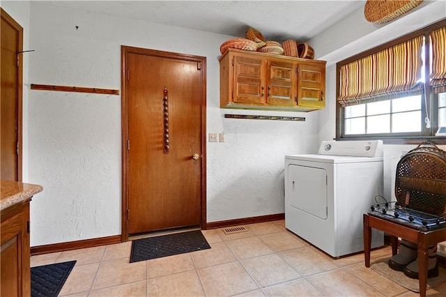 11814 W 149th St, Olathe, KS 66062 - washroom with washer / clothes dryer, a textured wall, and light tile patterned floors