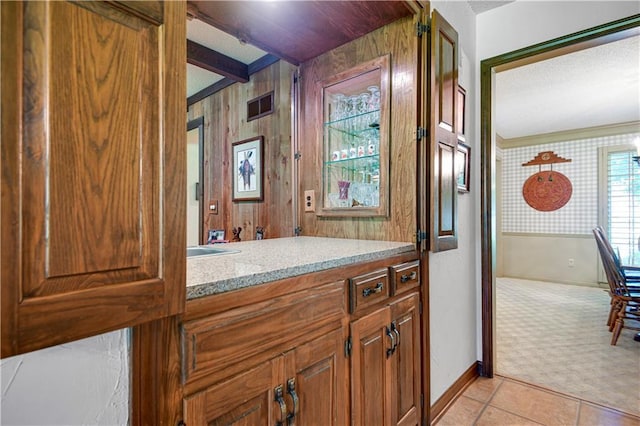 11814 W 149th St, Olathe, KS 66062 - bathroom featuring vanity, tile patterned floors, beam ceiling, and wood walls