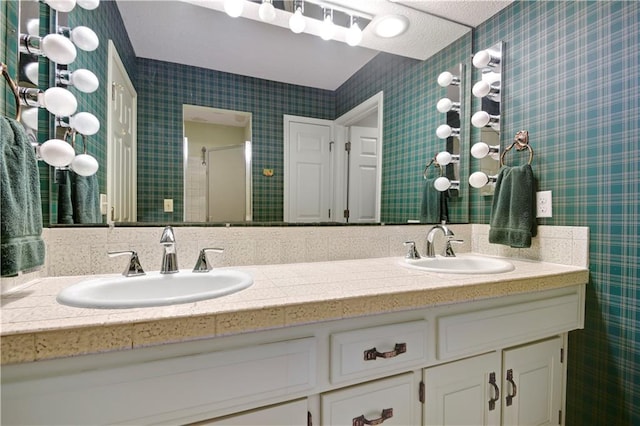 11814 W 149th St, Olathe, KS 66062 - bathroom featuring double vanity, wallpapered walls, and a shower with shower door