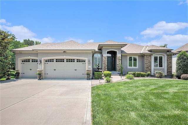 4512 NE Parks Summit Ter, Lees Summit, MO 64064 - prairie-style house featuring stone siding, a garage, stucco siding, concrete driveway, and a front yard
