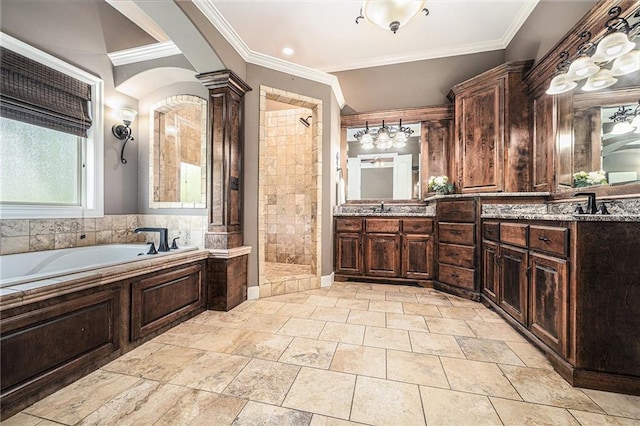 4512 NE Parks Summit Ter, Lees Summit, MO 64064 - bathroom featuring a bath, a tile shower, double vanity, crown molding, and decorative columns