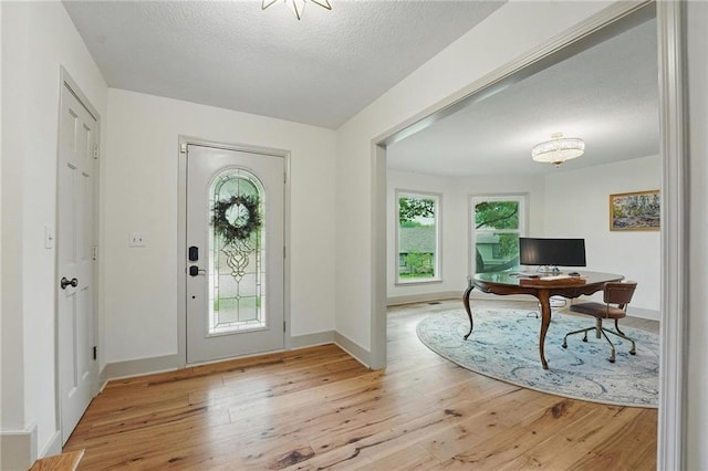3632 NW Blue Jacket Dr, Lees Summit, MO 64064 - entrance foyer with hardwood / wood-style floors, baseboards, and a textured ceiling