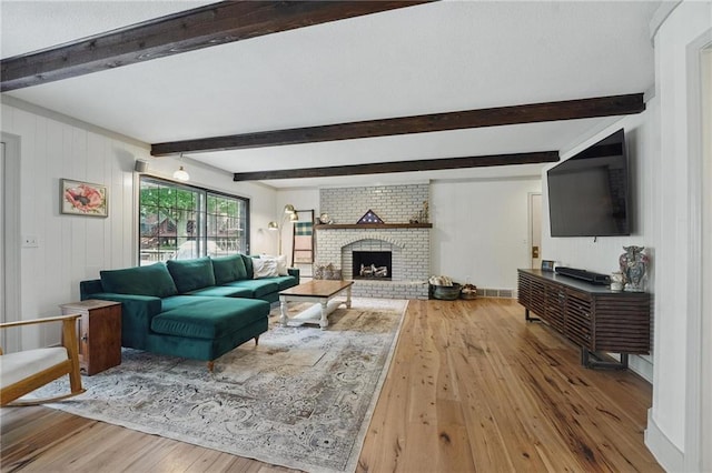 3632 NW Blue Jacket Dr, Lees Summit, MO 64064 - living area with wood-type flooring, beamed ceiling, and a fireplace