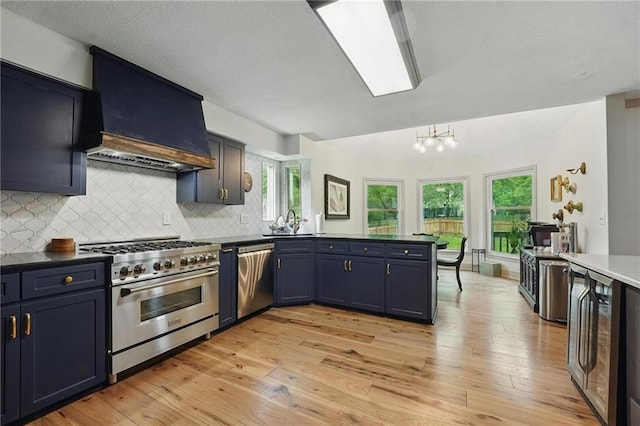 3632 NW Blue Jacket Dr, Lees Summit, MO 64064 - kitchen with stainless steel appliances, custom exhaust hood, beverage cooler, a sink, and light wood-style floors