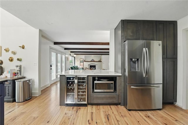 3632 NW Blue Jacket Dr, Lees Summit, MO 64064 - kitchen featuring stainless steel appliances, wine cooler, light wood finished floors, a peninsula, and light countertops