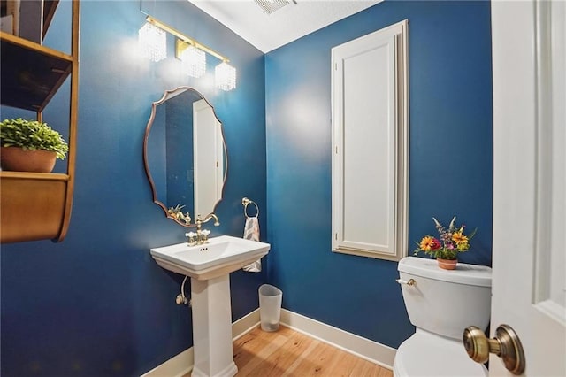 3632 NW Blue Jacket Dr, Lees Summit, MO 64064 - half bathroom with toilet, wood finished floors, and baseboards