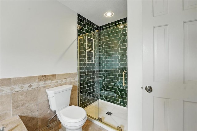 3632 NW Blue Jacket Dr, Lees Summit, MO 64064 - full bathroom featuring a stall shower, toilet, tile walls, and a wainscoted wall